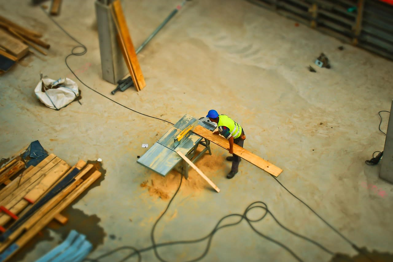 Contractor cutting a piece of wood.