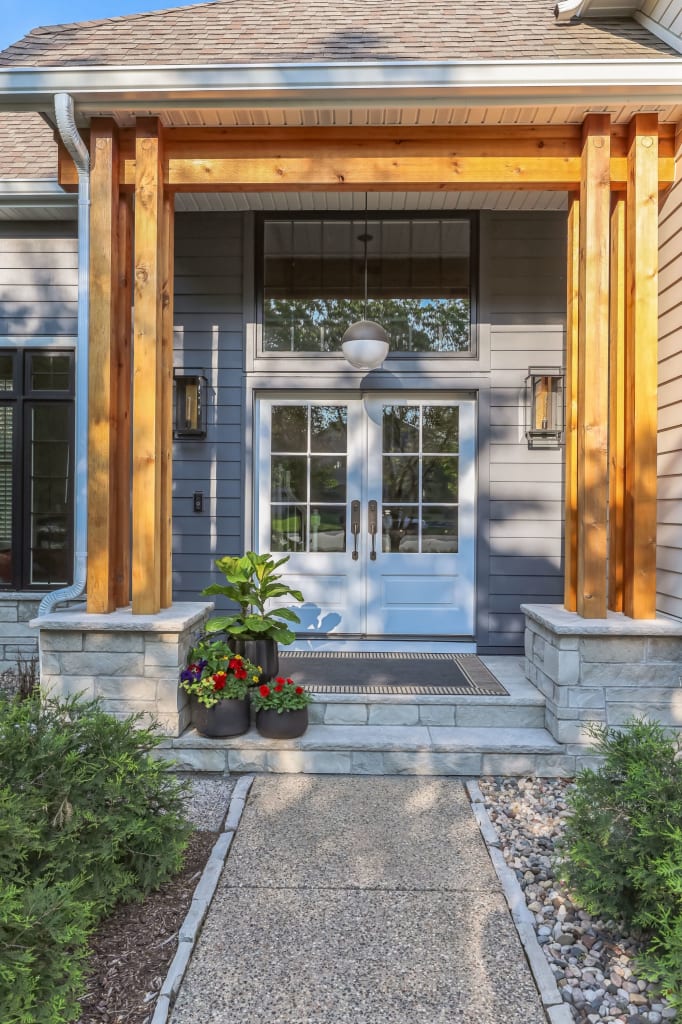 A close up of the entrance of a home with new siding