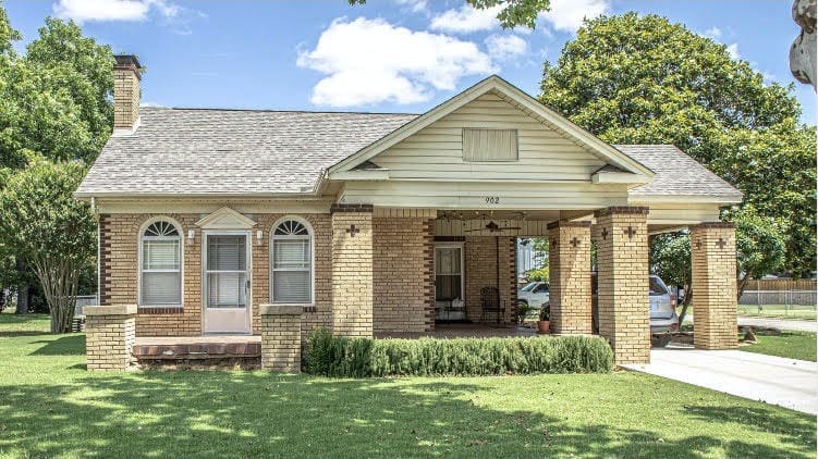 Home exterior with a covered front door and off-white siding.