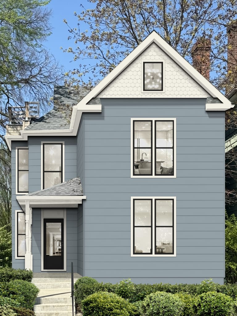Victorian style home with black windows, light blue siding, and a black front door.