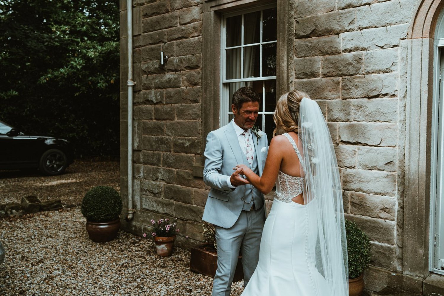 Faye's father about to hug her on her wedding day