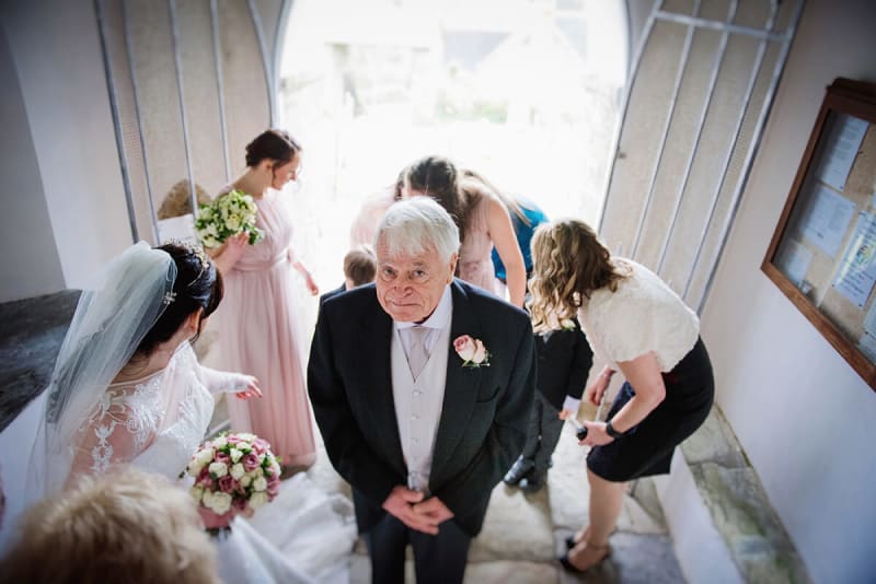 bride's dad looking up at camera during her wedding