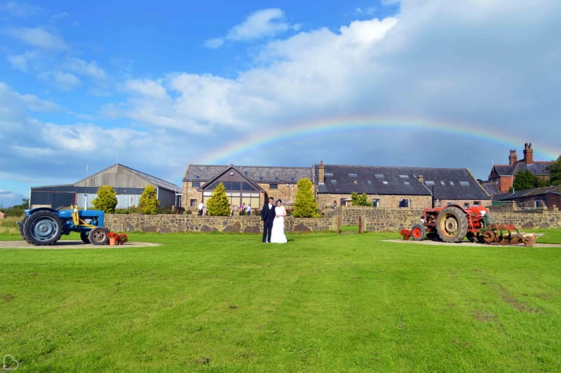 a couple poses on a sunny day outside beeston manor