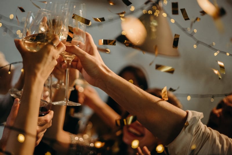 People celebrating at wedding party with biodegradable confetti in the air