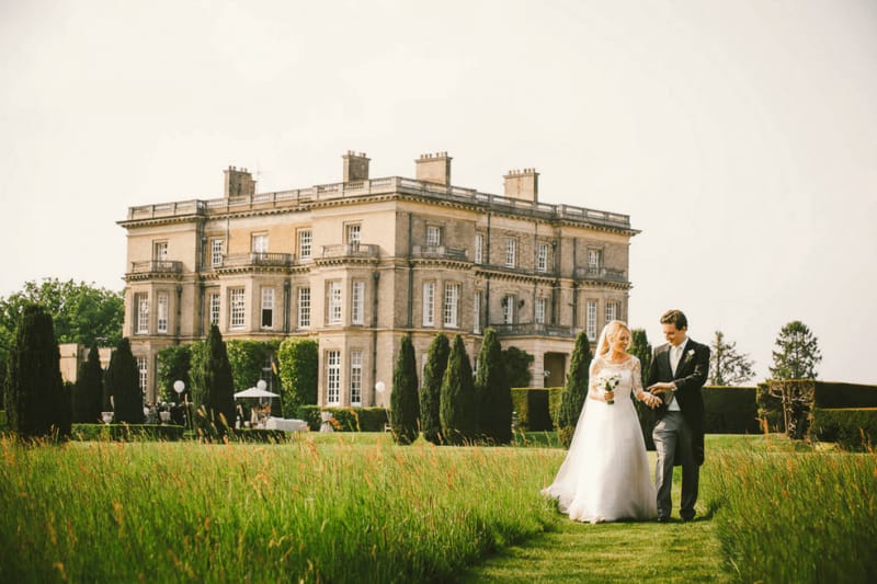 hamish shephard and rosie shephard in from of hedsor house during their wedding