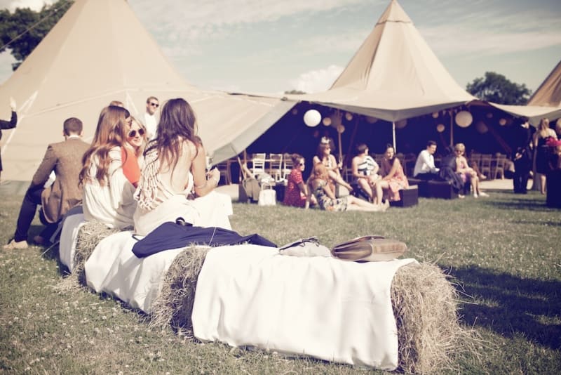 Bridebook.co.uk- guests sitting on hay bells