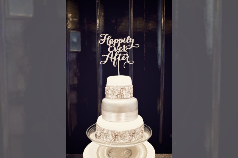 Bridebook.co.uk- white cake with metallic accents and a happily ever after topper