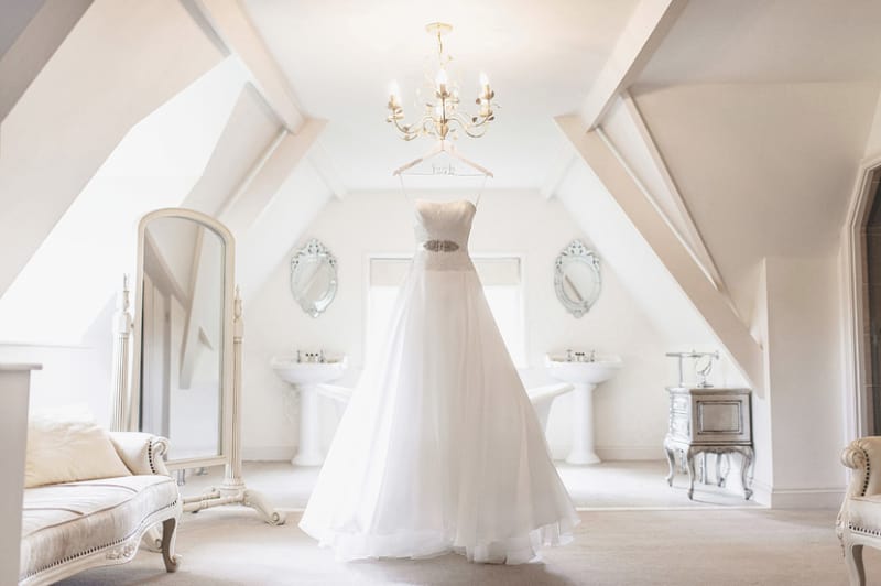 Bridebook.co.uk- white wedding dress hanging up in bridal suite