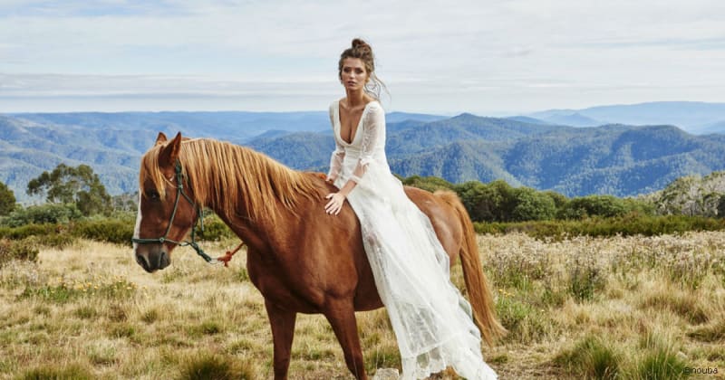 Bridebook.co.uk bride in wedding dress and bridal hair on horse