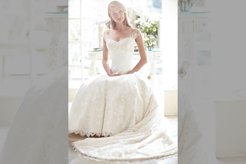 bridebook.co.uk-phillipa-lepley dress on model sitting with hands in lap