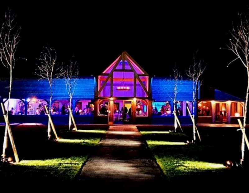 Barn venue lit up at night. 