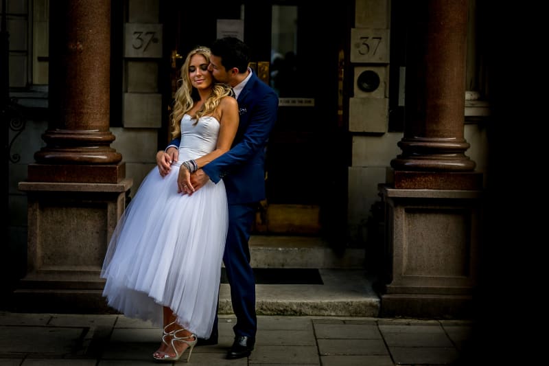 Bridebook.co.uk- groom hugging and kissing bride