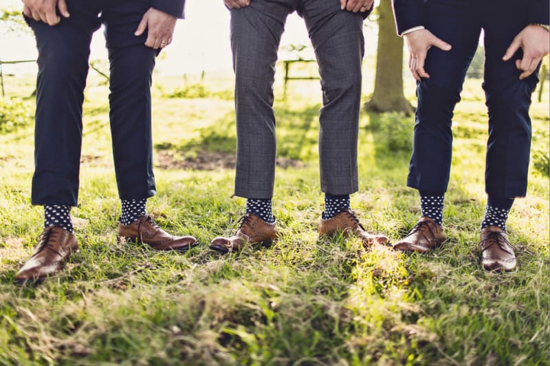 Bridebook.co.uk- ushers showing off matching polka dot socks