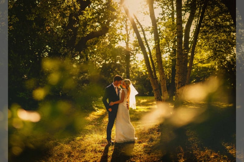 Bridebook.co.uk- bride and groom hugging in a forest