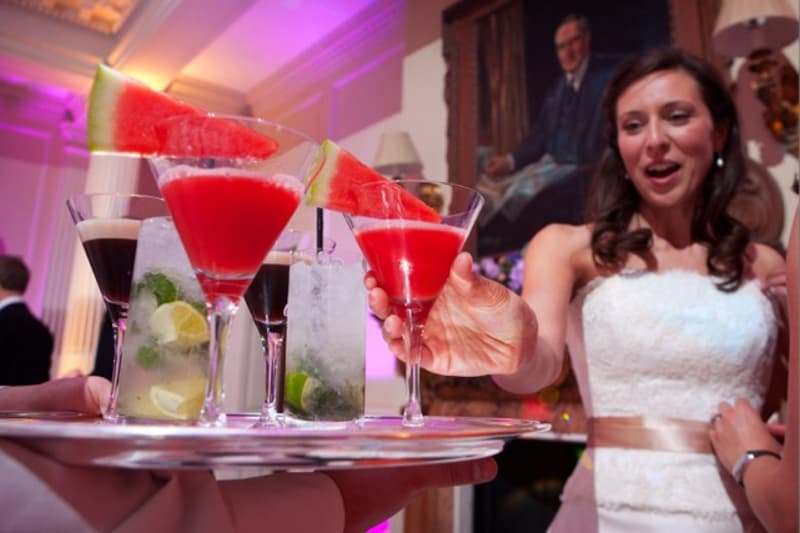 Bridebook.co.uk- bride reaching for a watermelon cocktail