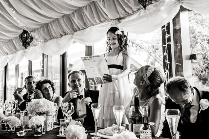 Bridebook.co.uk- flower girl reading to the guests