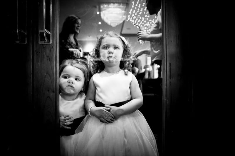 Bridebook.co.uk- flower girls pressing up faces against glass