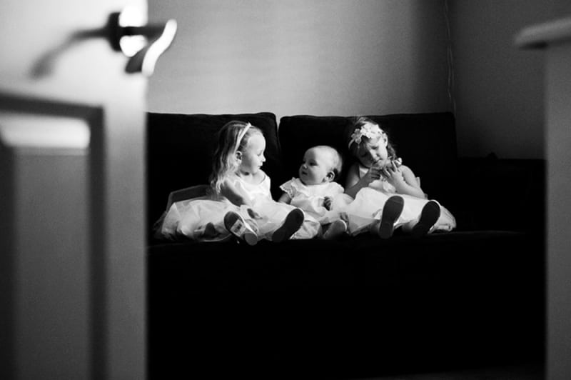 Bridebook.co.uk- flower girls sitting on a sofa