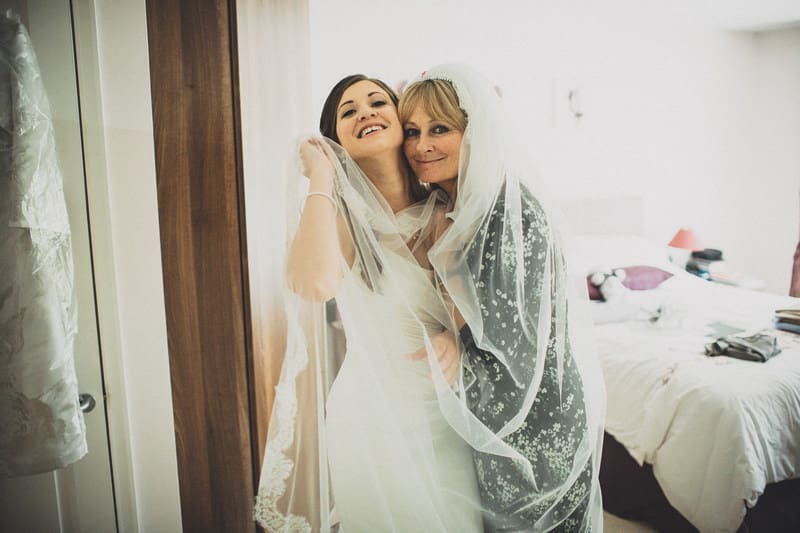 Bridebook.co.uk- mother and bride hugging under the veil