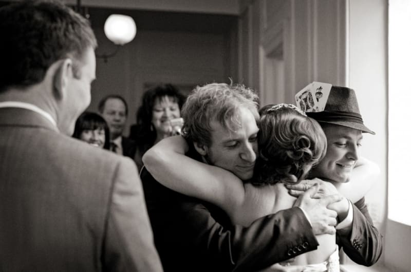 Bridebook.co.uk- bride hugging guests