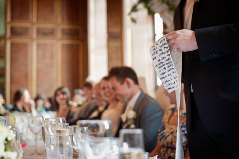 Bridebook.co.uk- best man holding a long scroll with his speech on it