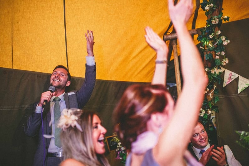 Bridebook.co.uk- best man giving his speech as guests cheer