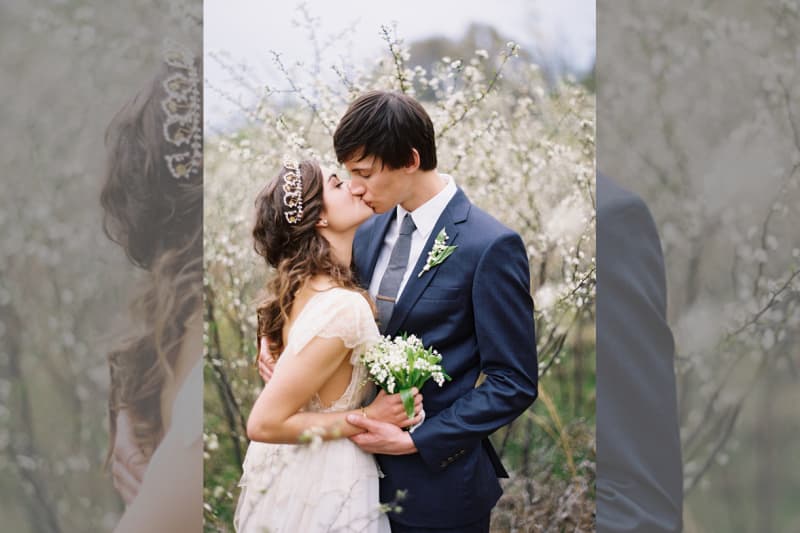 bridebook.co.uk bride and groom outdoors with a tiara