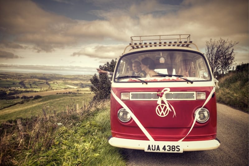 Bridebook.co.uk- bride and groom in red vw wagon