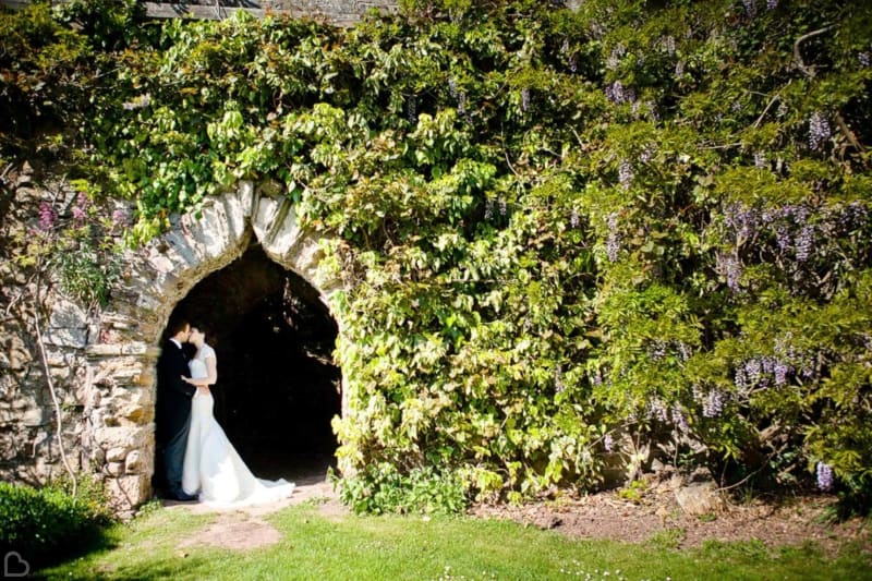 a married couple kisses in berkeley castle