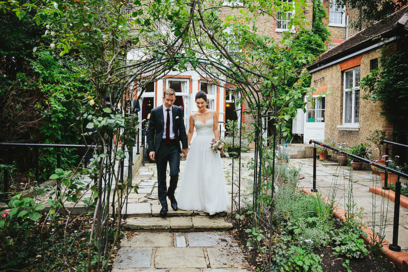 Newlyweds walk outside The Register Office