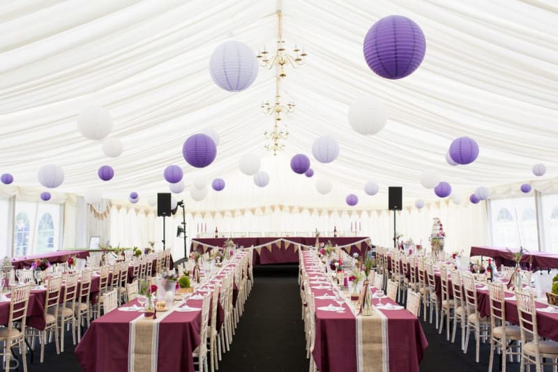 Wedding marquee decorated with lavender paper spheres.