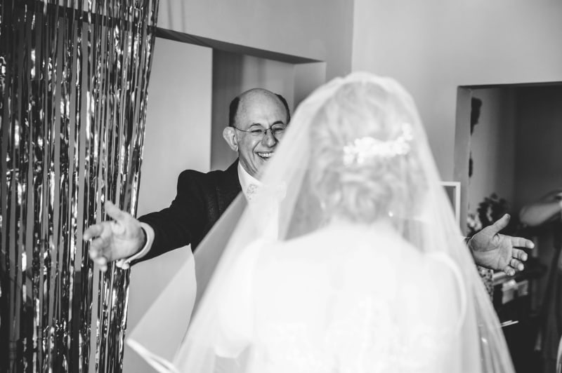 Faye's father about to hug her on her wedding day