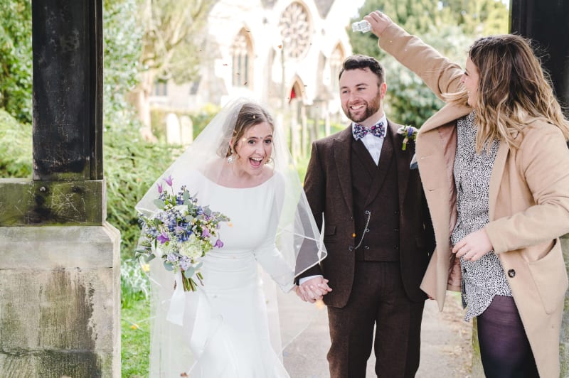 Adam and Faye Hughes holding hands on their wedding day