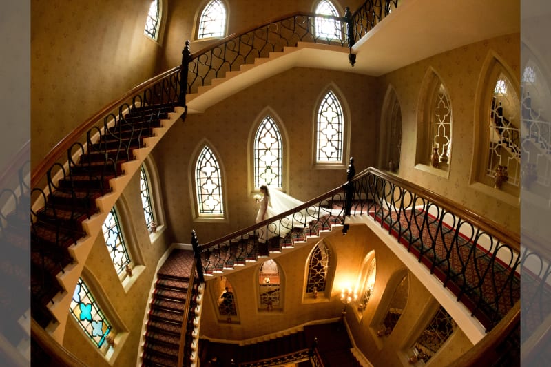 bridebook.co.uk photograph by john nassari of bride walking down stairs