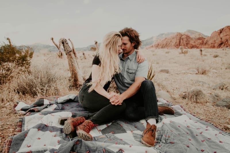 Couple in love sitting together on blanket