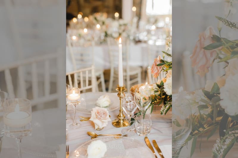 A white candle on top of a table.