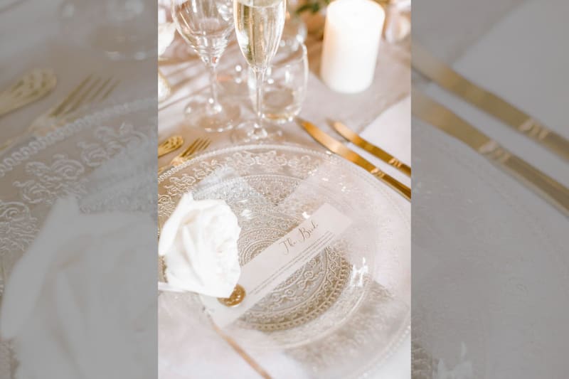 A white plate with a paper on top of it that reads "The Bride".