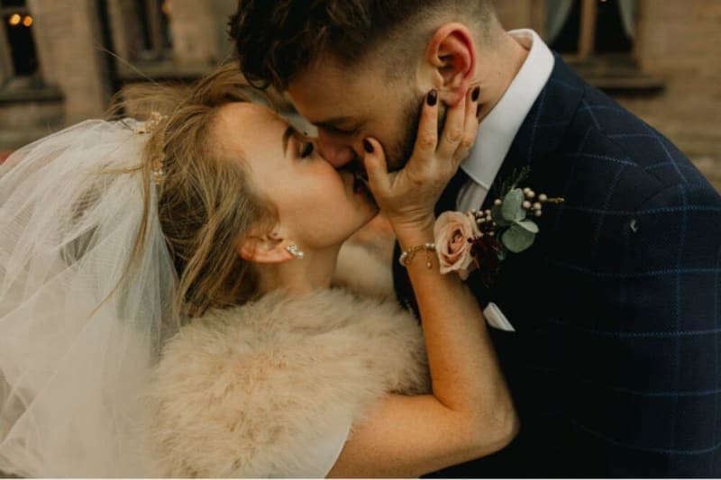 The bride and groom kissing.