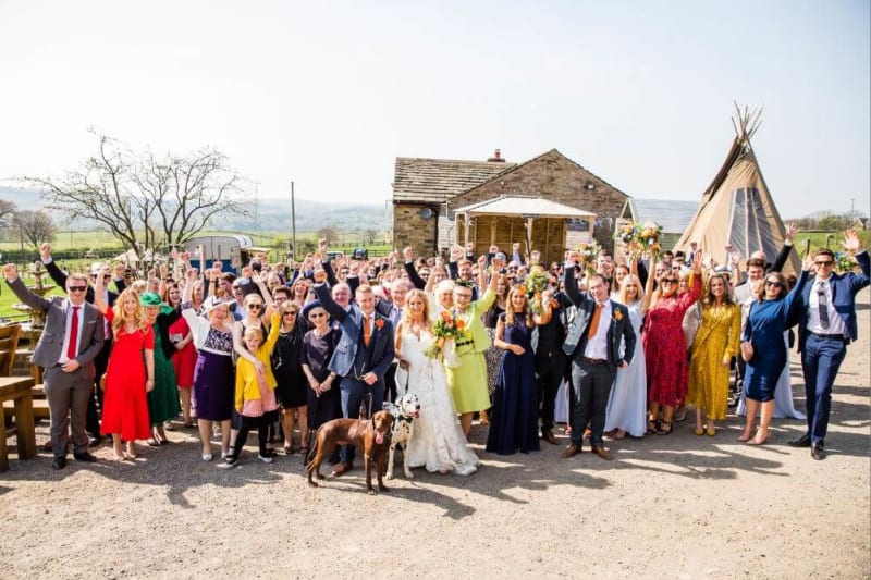 The party guests outside with their hands in the air.