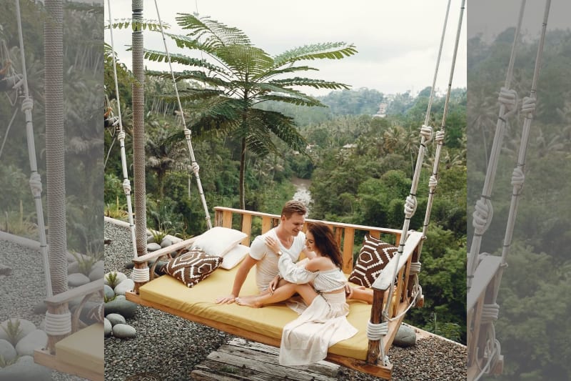 Couple relaxing on swing on holiday