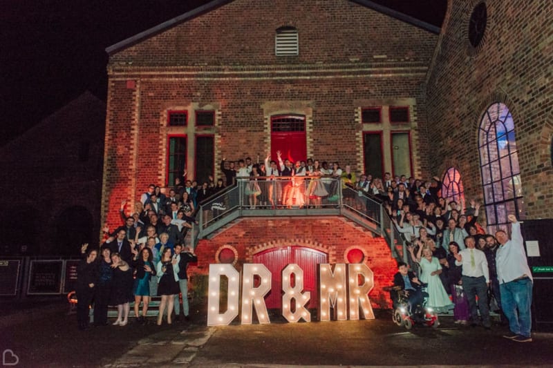 Whole wedding party photo outside on the national mining museum scotland