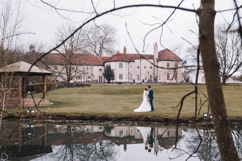 Newlyweds kiss by the late at the amazing place in essex