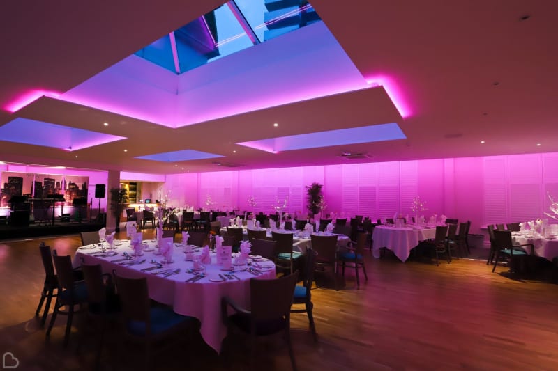 Dining room at the Marsham Court Hotel, with pink and purple lighting and a skylight. 