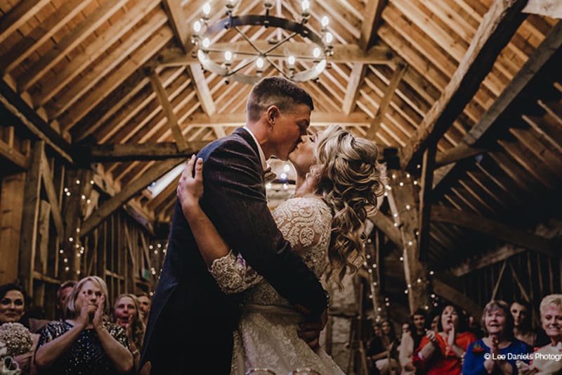 Newlyweds kiss at Bassmead Manor barns