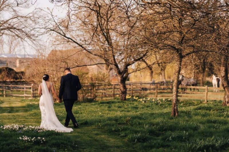 Bride and Groom holding hands and walking.