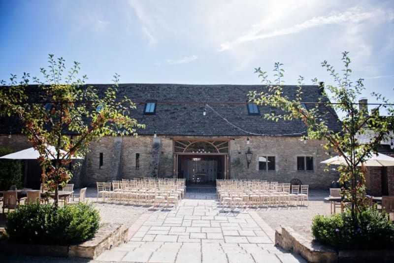 The barn is viewed from the outside on a sunny day.