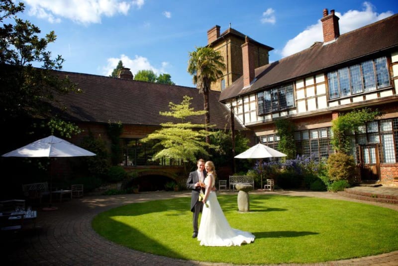 Bride and Groom embrace in the lawn outside the house.