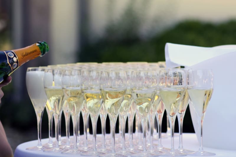 Glasses of champagne being filled up.