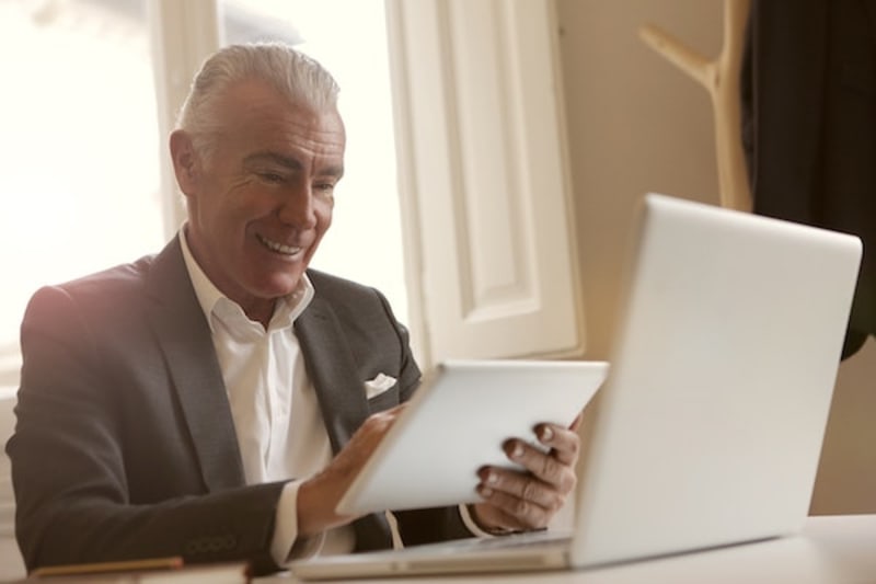 man smiling with gadgets
