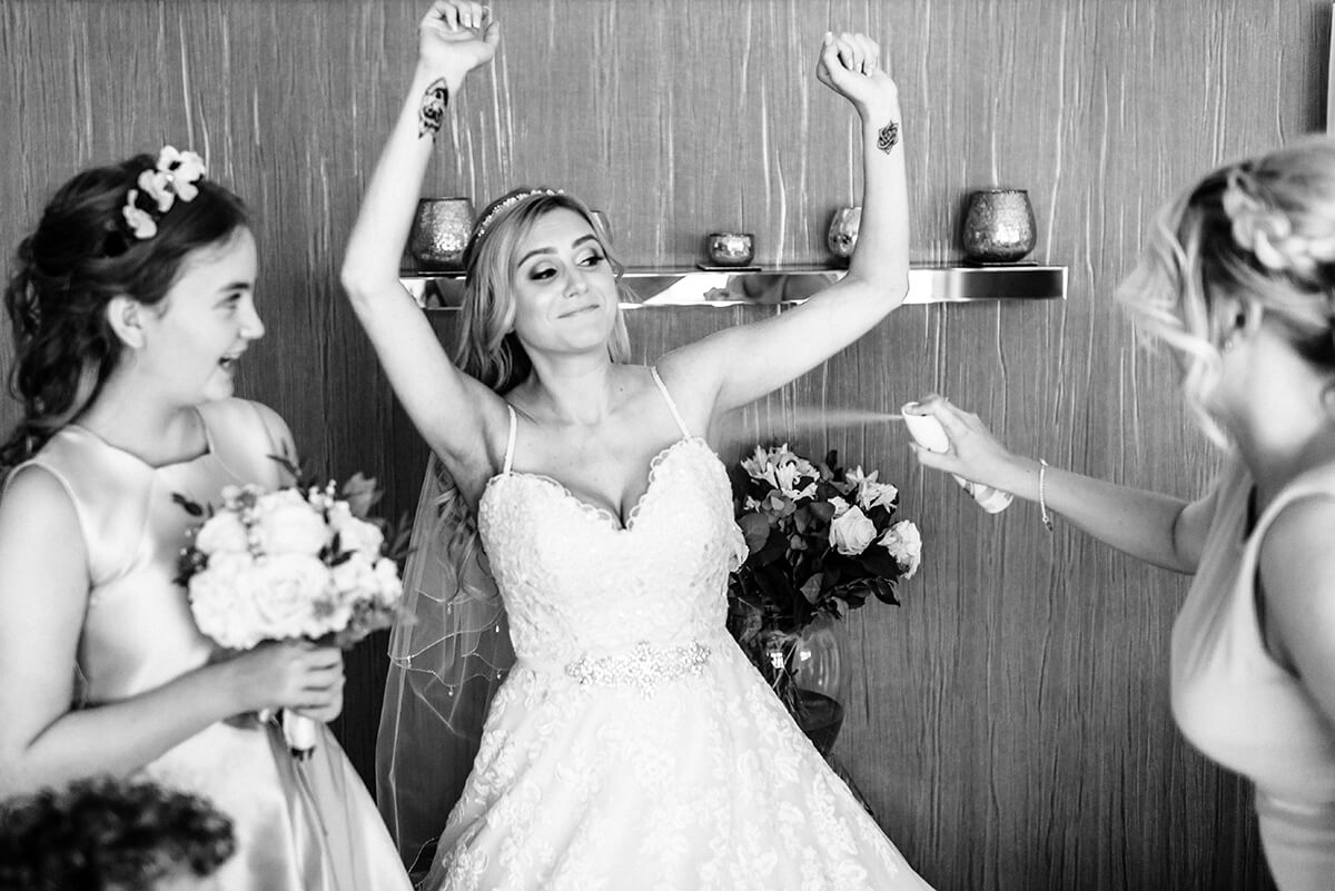 bridesmaid spraying deodorant on her bride. best wedding photos of 2018